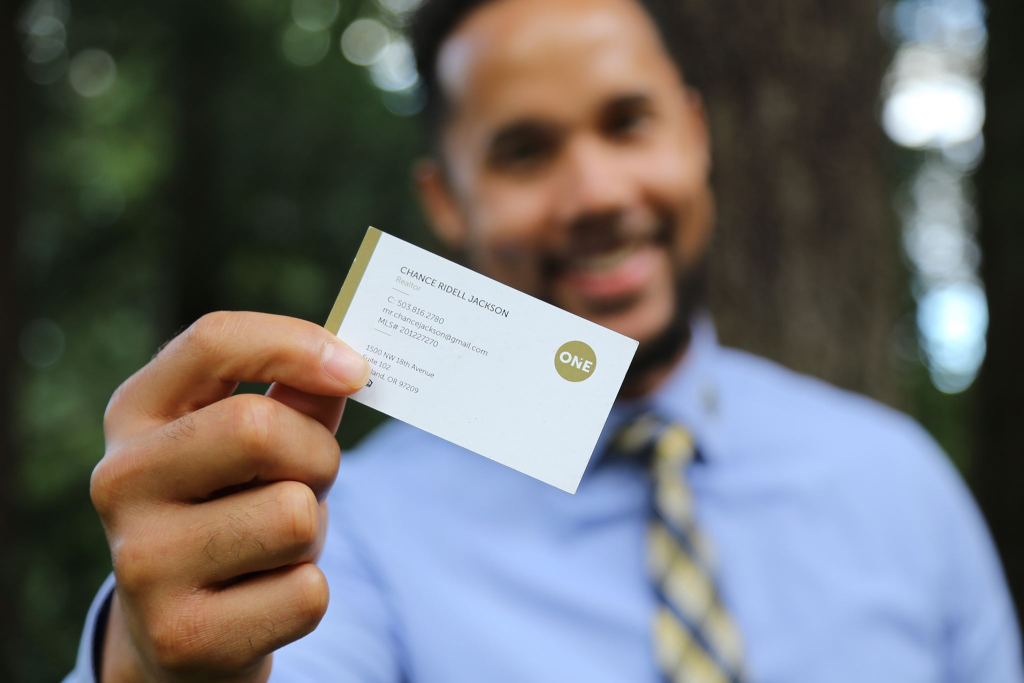 Chance Jackson handing you a business card for real estate.
